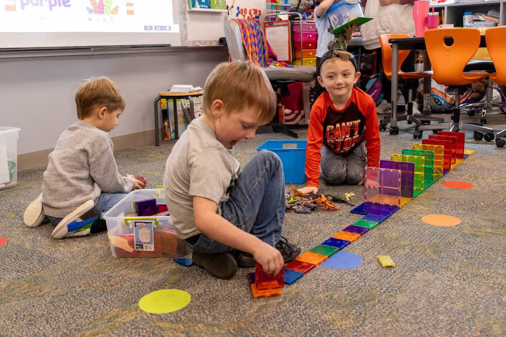 Kids playing with magnet tiles.