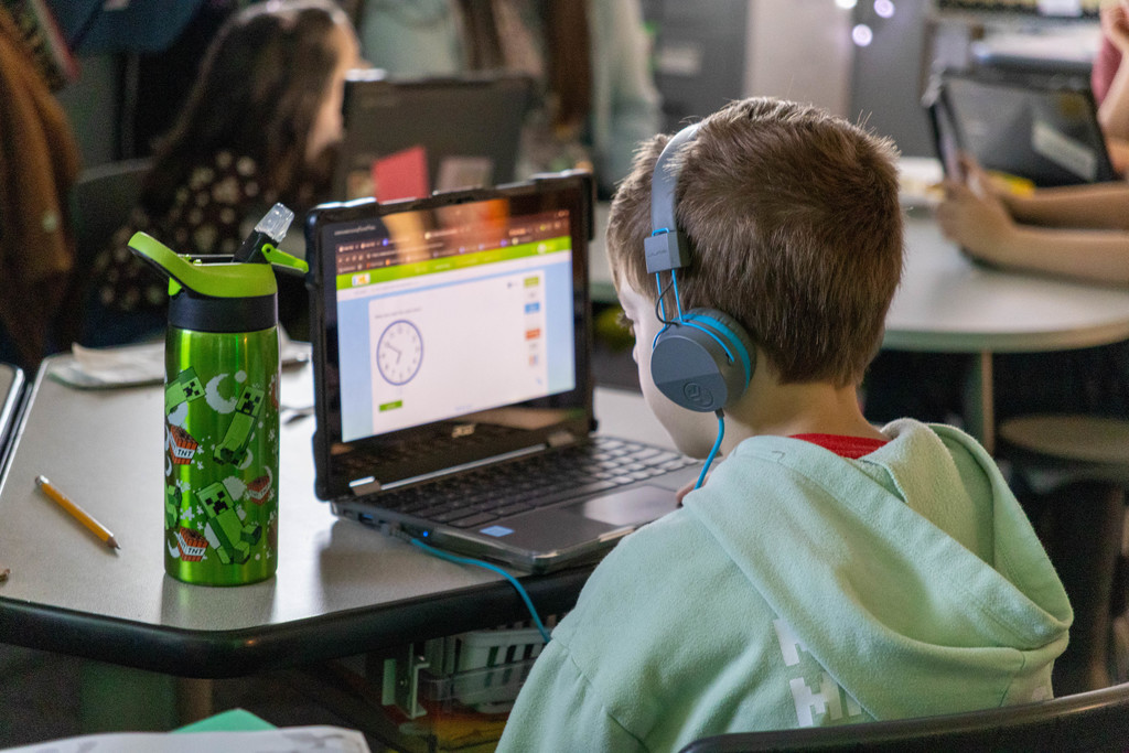 Kid doing math on computer.