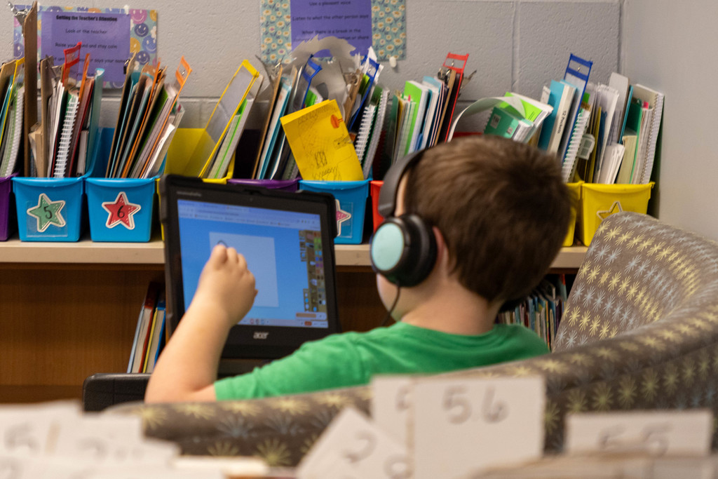 Kid working on reading work.