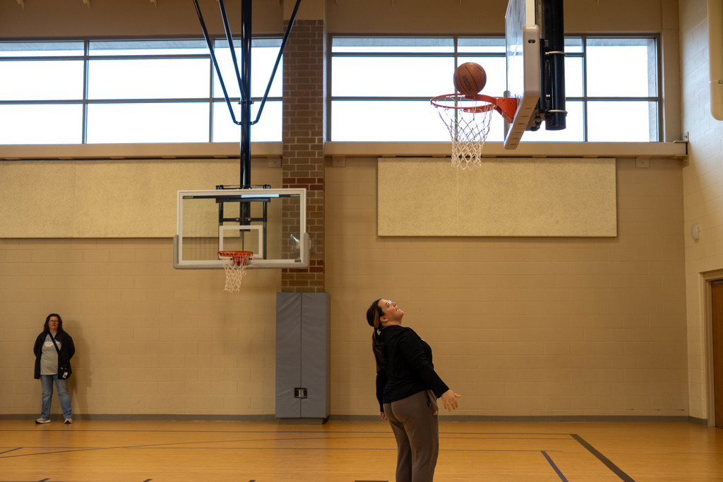 Teacher playing basketball.