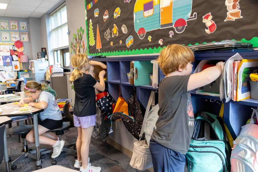 Students looking in their cubbys.