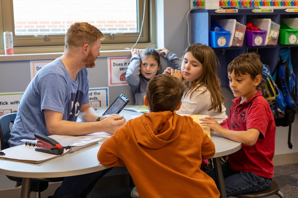 Teacher and kids doing a group reading.