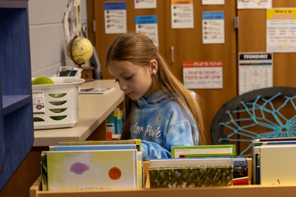 Kid looking at class library.