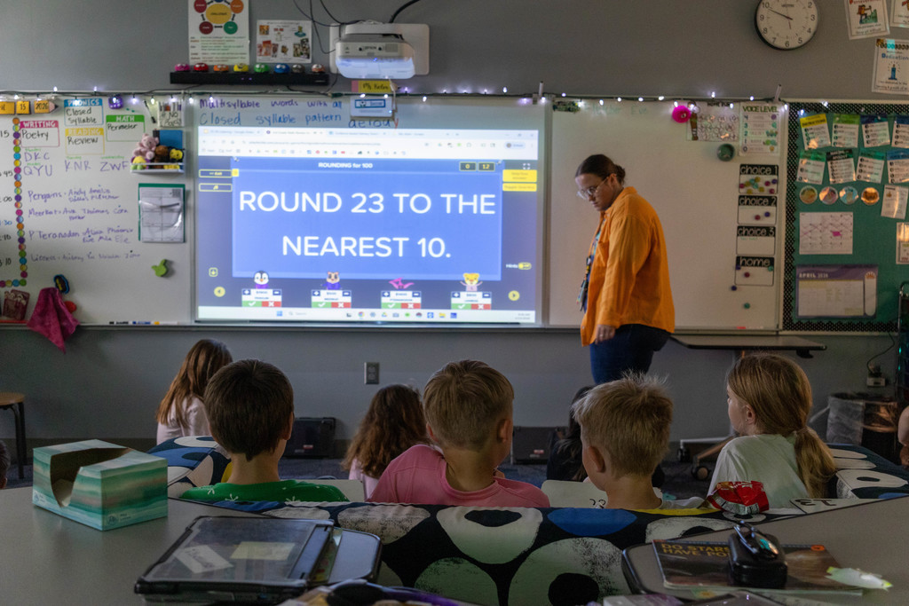 Teacher and kids playing math game.