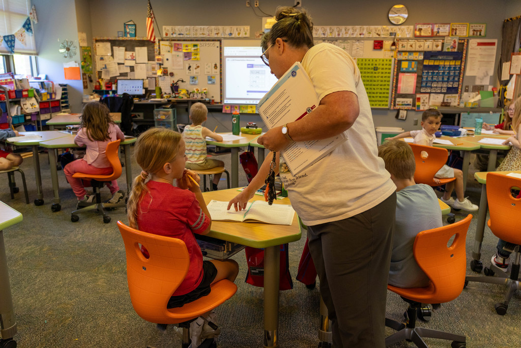 Teacher helping kid.