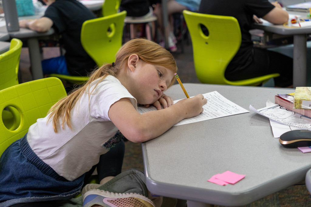 Kid writing on paper.
