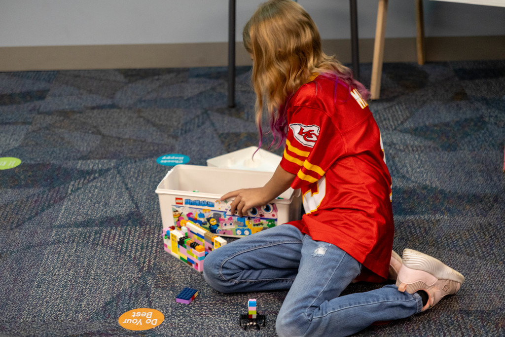 Kid playing with legos.
