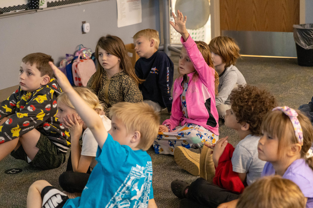 Kids raising their hands.