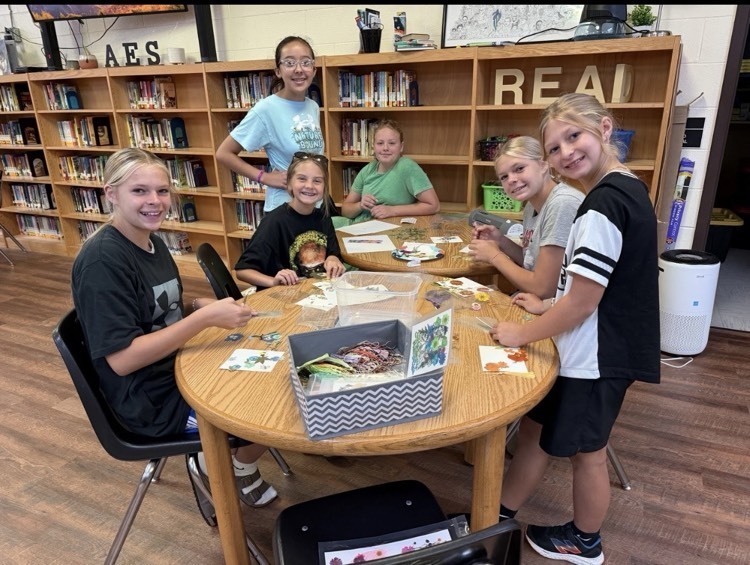 students creating dried flower bookmarks at library 
