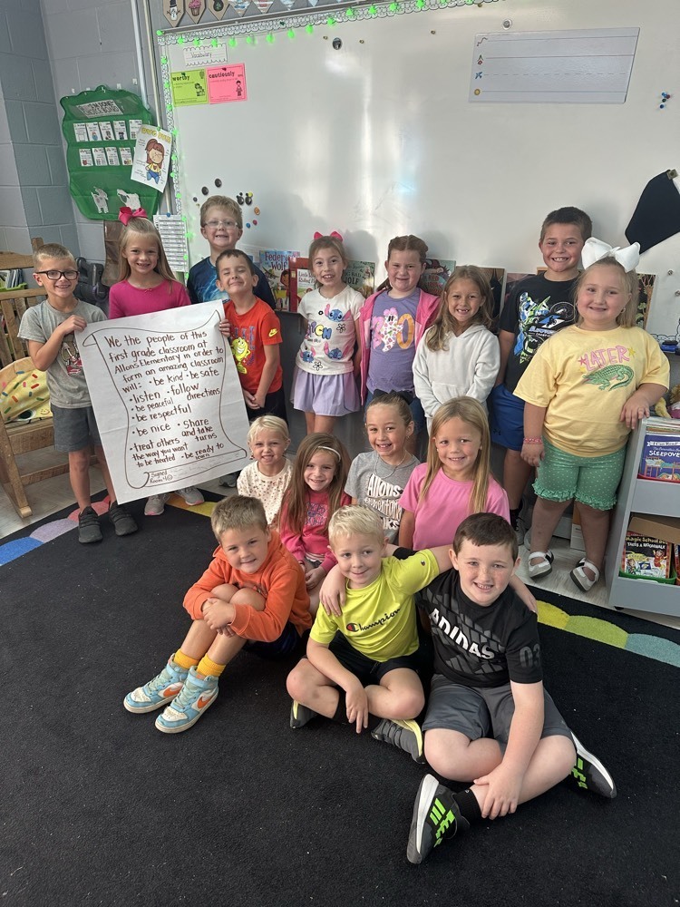 Miss Delk’s 1at grade class posing with their classroom constitution 
