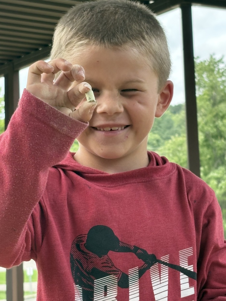 student holding fossil