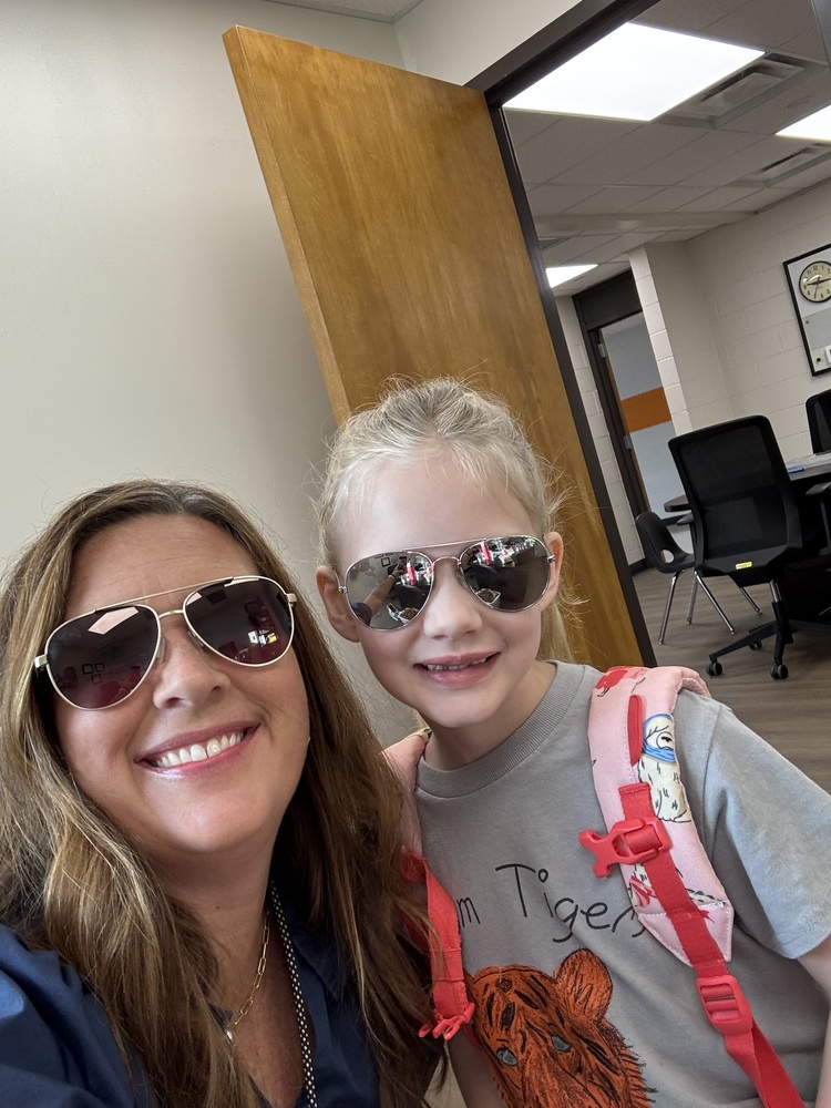A student posing with Mrs. Choate