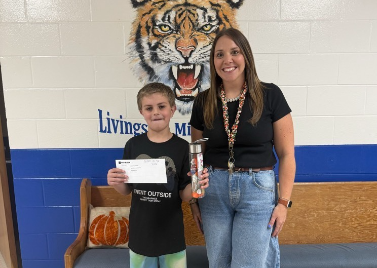 student and assistant principal with prizes 