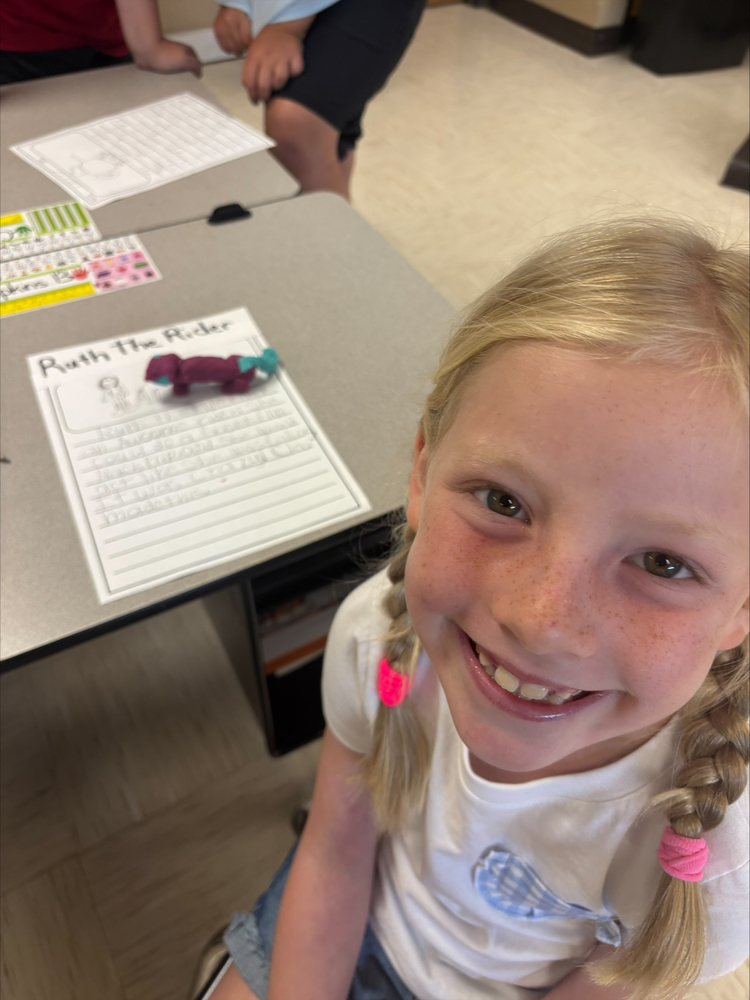 Student working with playdough creating  fairytale characters 