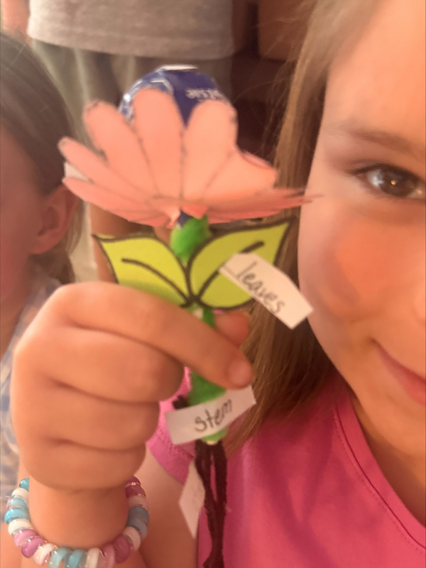 student holding a flower