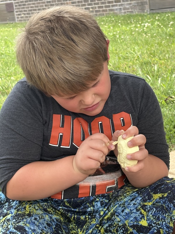 student digging for fossils