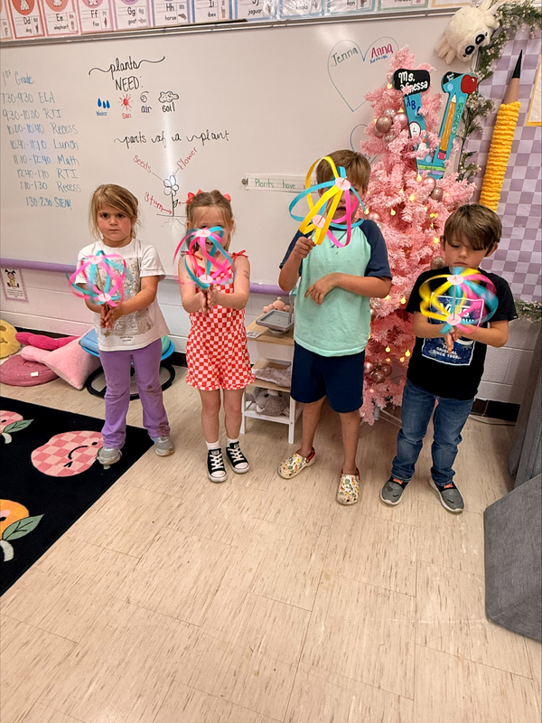 students holding art work