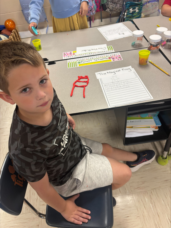2nd grade students creating fairytale characters with Play Doh