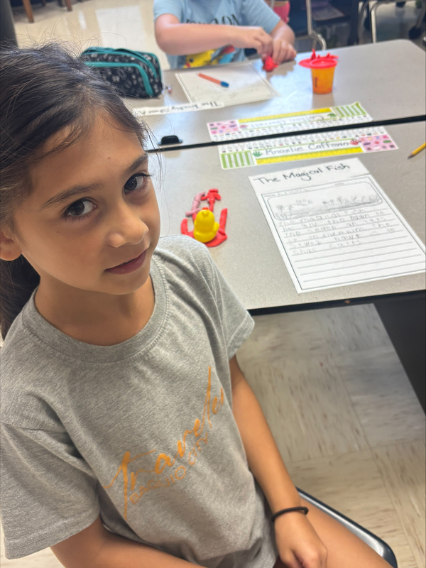 2nd grade students creating fairytale characters with Play Doh