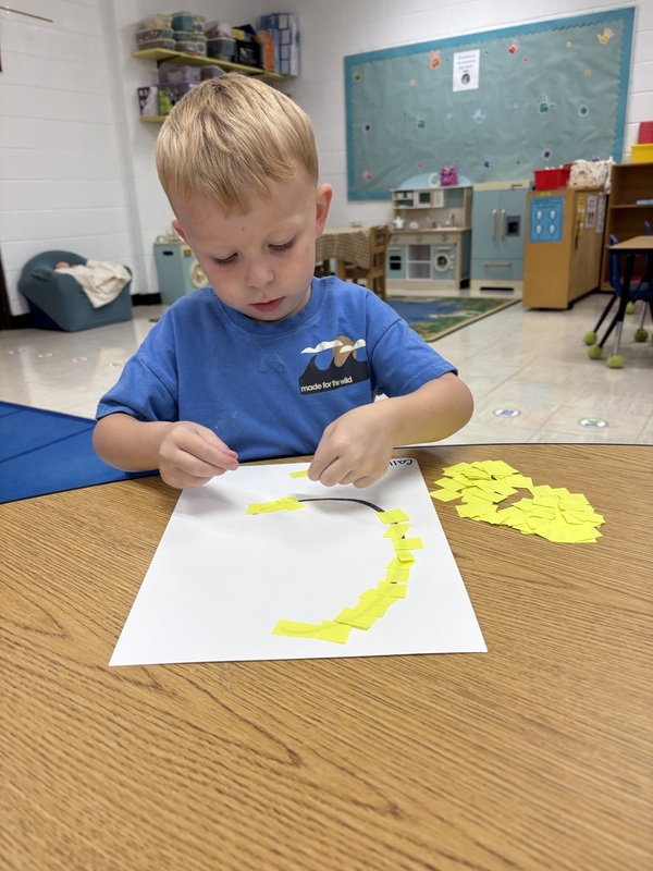 Pre-K student working on fine motor skills tracing letters