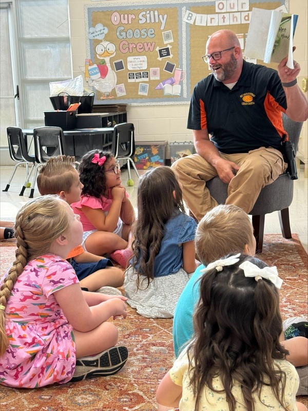 Officer Chris Carter reading to Kindergarten
