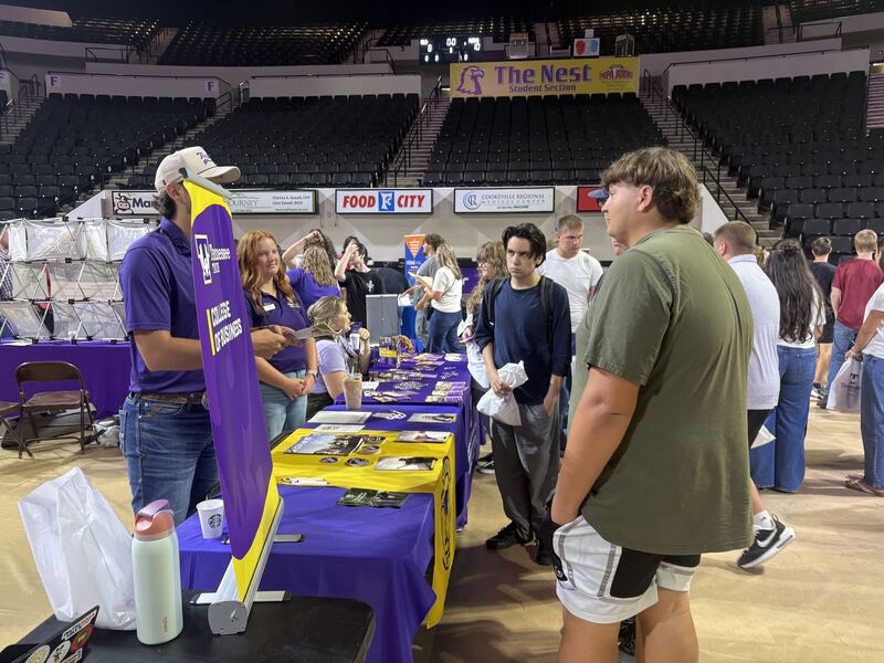 Students speak with college representatives.
