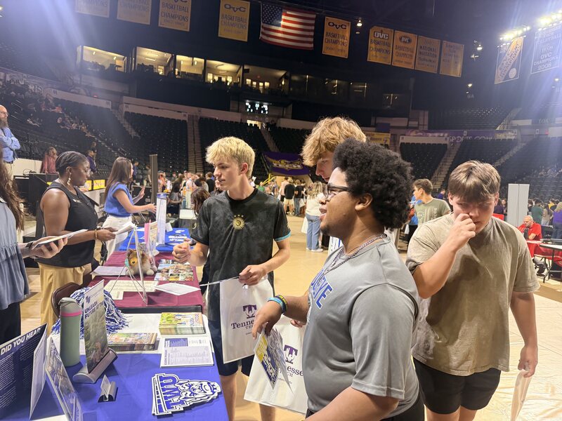 Students speak with college representatives.