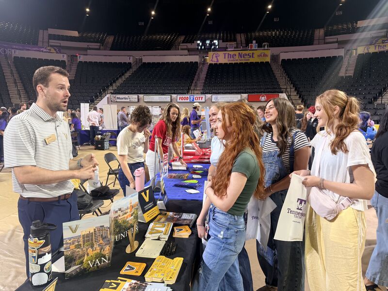 Students speak with college representatives.