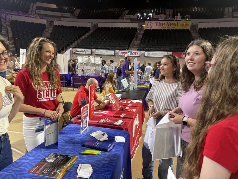 Students speak with college representatives.