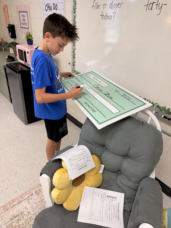 student learning to write a check