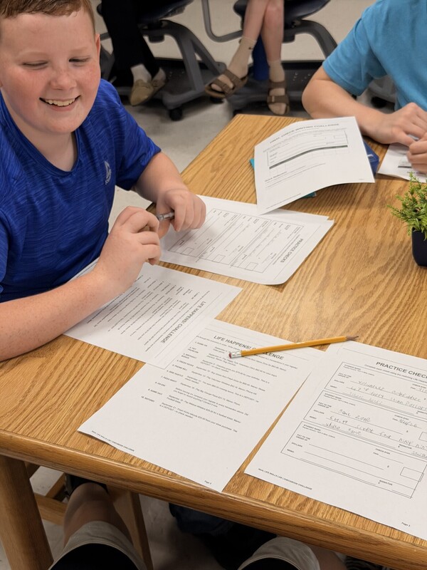 student learning to write a check