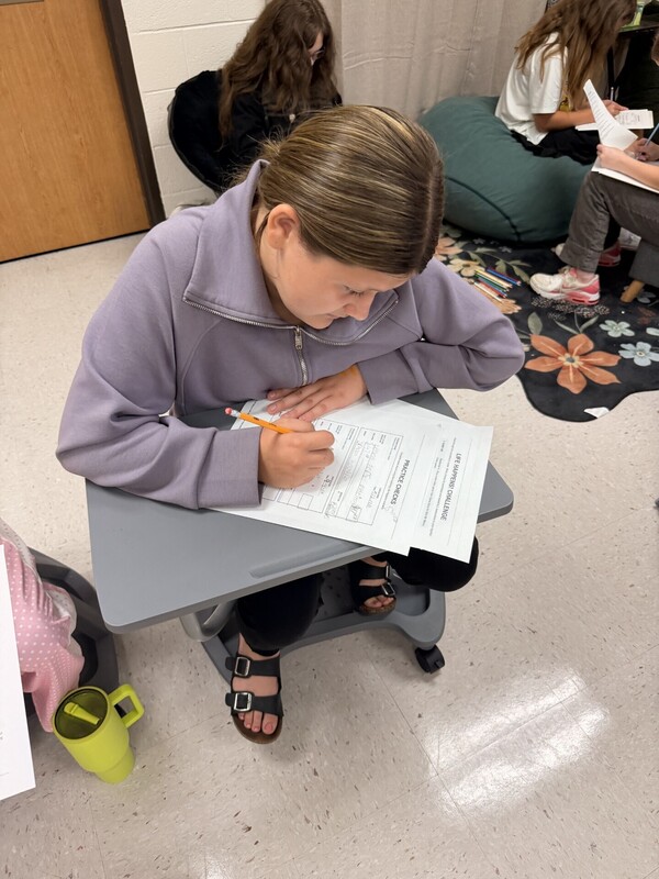 student learning to write a check