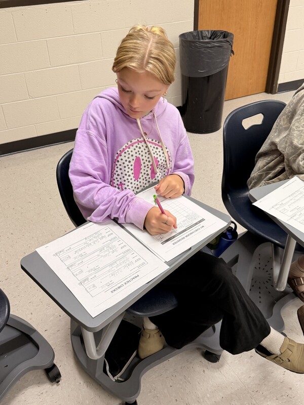 student learning to write a check