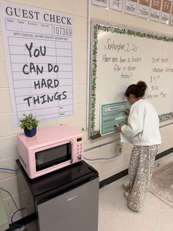 student learning to write a check