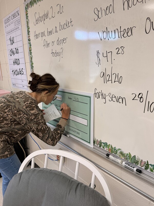 student learning to write a check