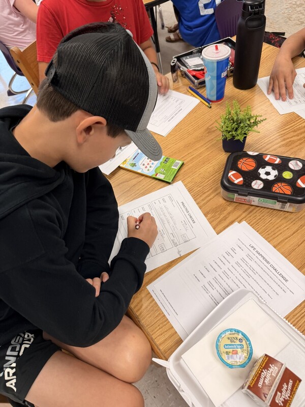 student learning to write a check