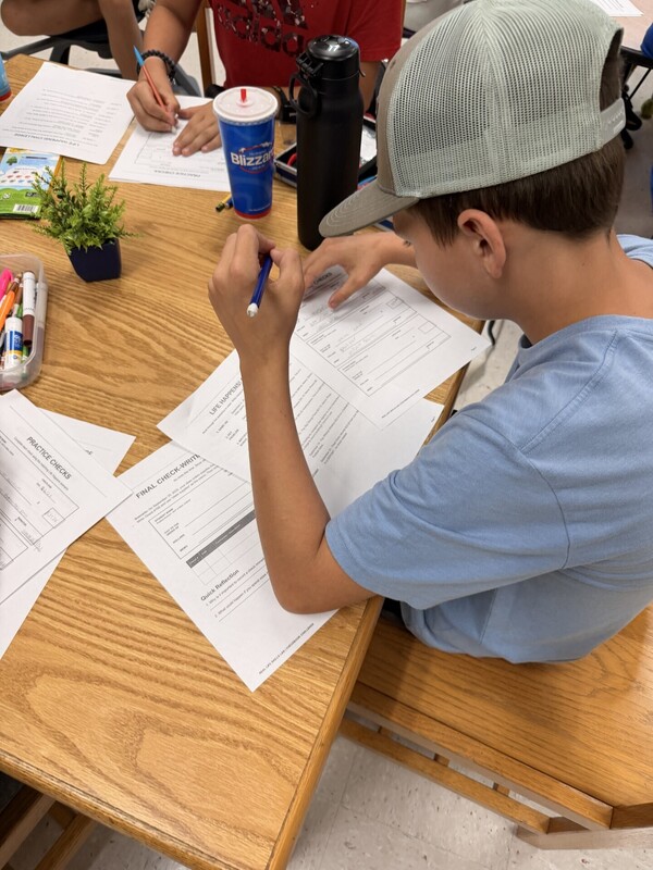 student learning to write a check