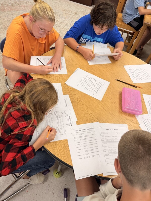 student learning to write a check