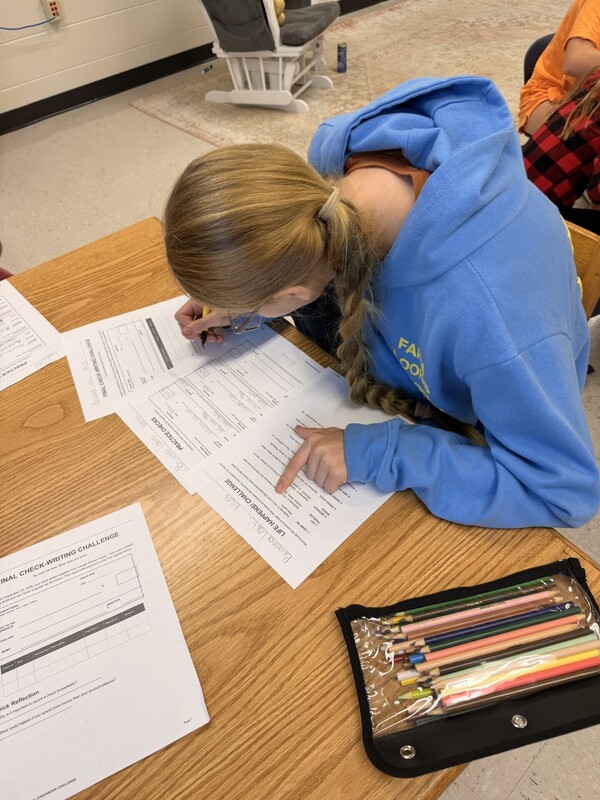 student learning to write a check