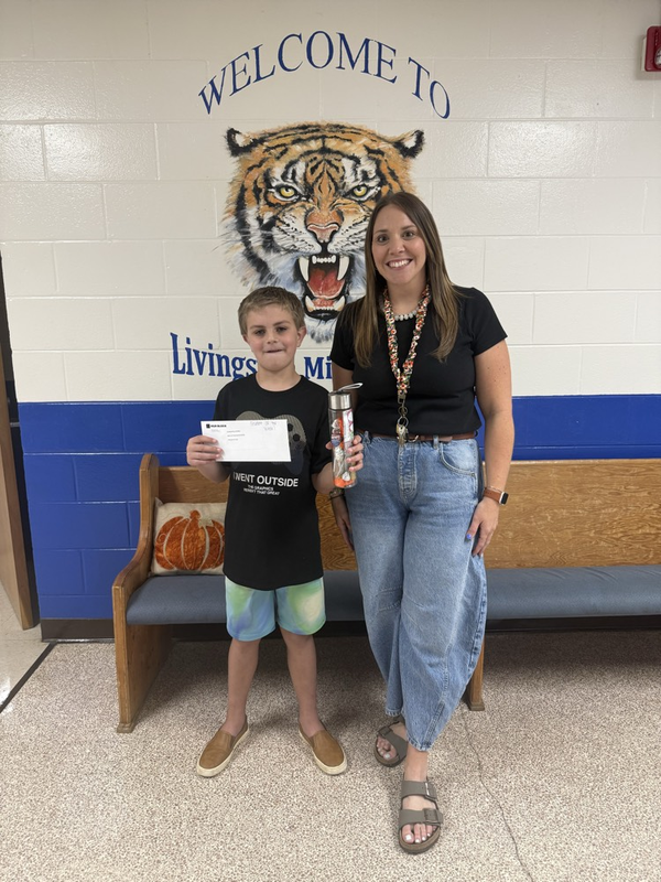boy and assistant principal with prizes