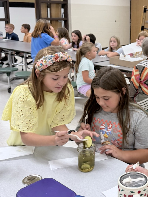3rd graders tasting their pickles they canned