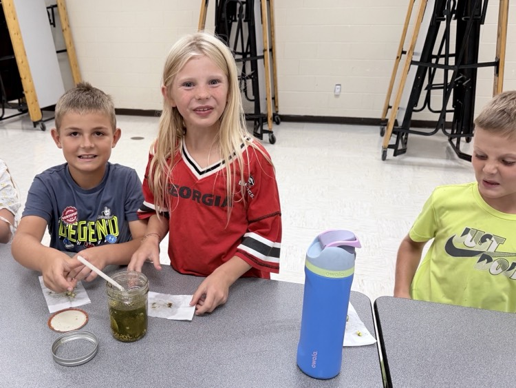 3rd graders tasting their pickles they canned
