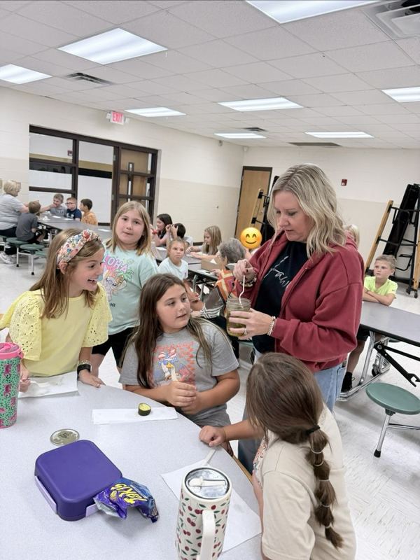 Mrs. Goolsby joining the pickle fun and trying the pickles