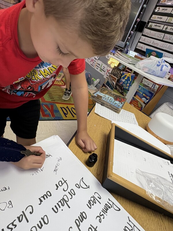 1st Grade signing their classroom constituioln