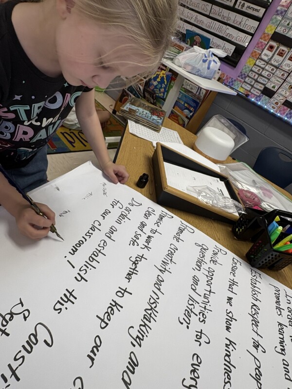 1st Grade signing their classroom constituioln