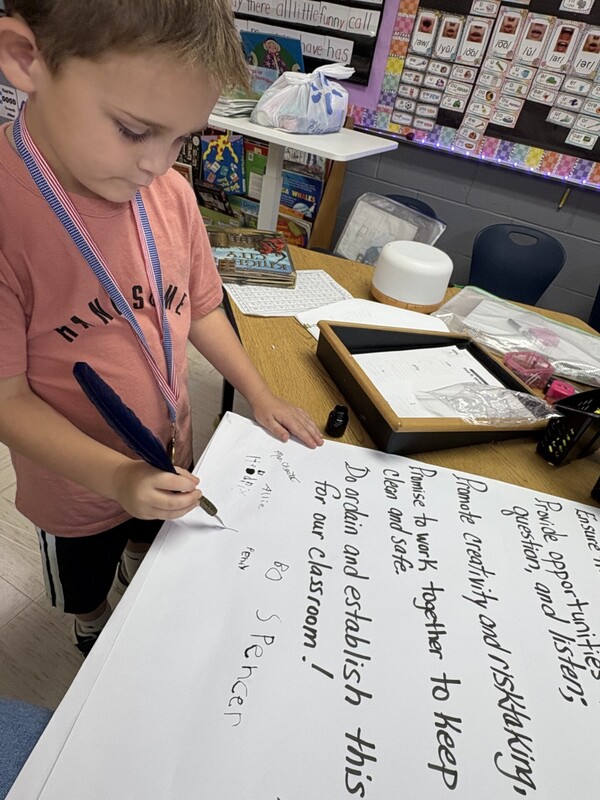 1st Grade signing their classroom constituioln