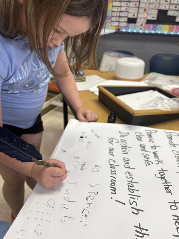 1st Grade signing their classroom constituioln