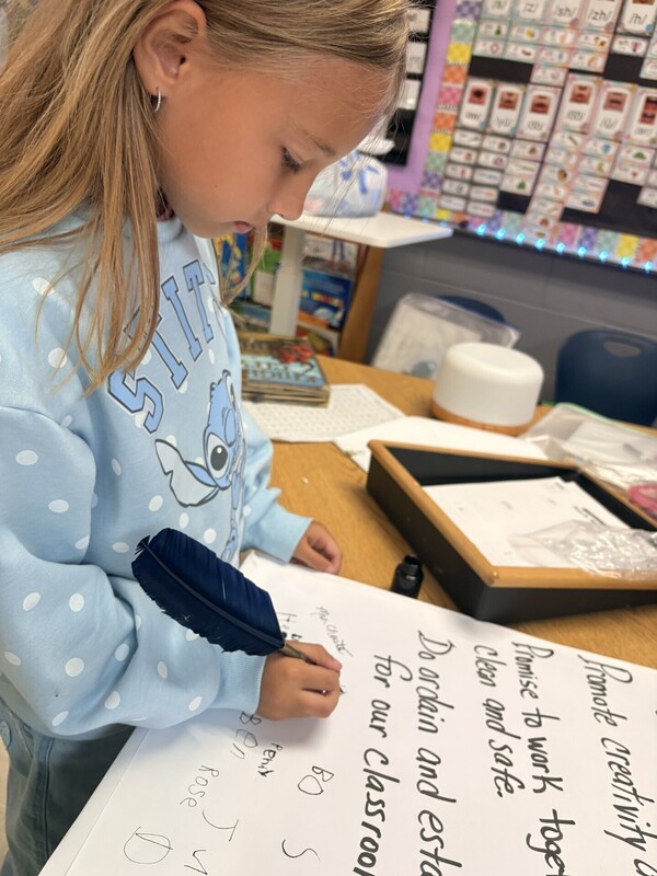 1st Grade signing their classroom constituioln