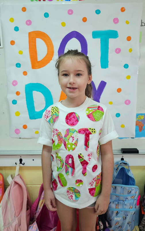 students wore fun dot themed shirts. Mrs. Vicky’s student posing with her shirt