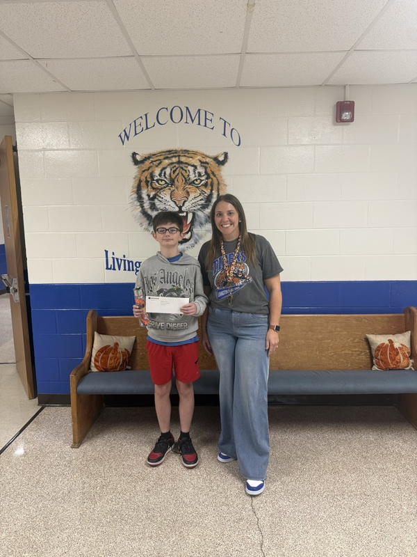 boy with prize and assistant principal 
